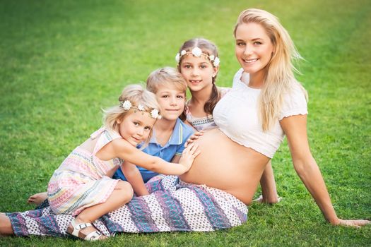 Happy pregnant mother with kids