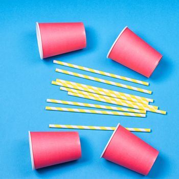 Colorful paper cups and striped straws