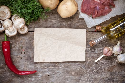 Raw ingredients, potatoes, meat, mushrooms, parsley, oil, pepper