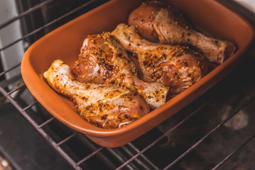 marinated raw chicken legs are in the oven, retro toning
