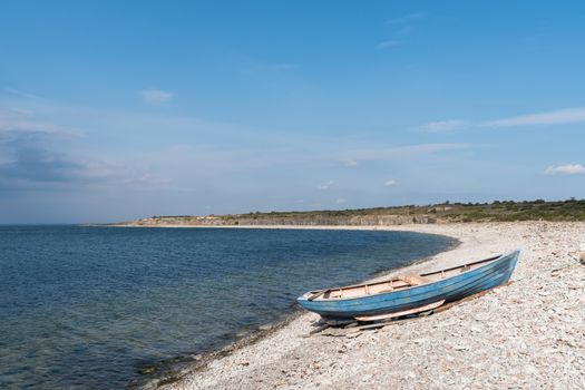 Blue rowing boat by seaside