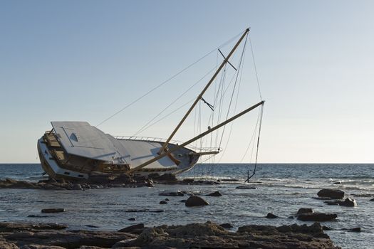 Sailing ship stranded on the rocks