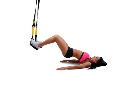 Woman exercising with suspension straps