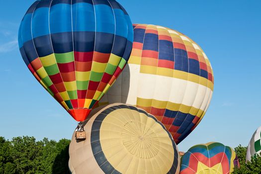 Colorful hot-air balloons ready to get up in flight