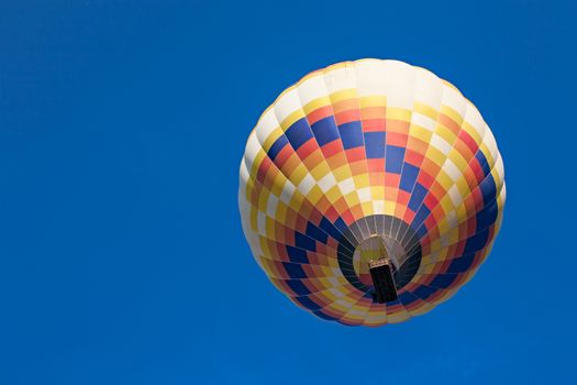 Colorful hot-air balloon in flight seen from below