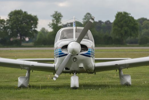 Front view of a plane on a lawn
