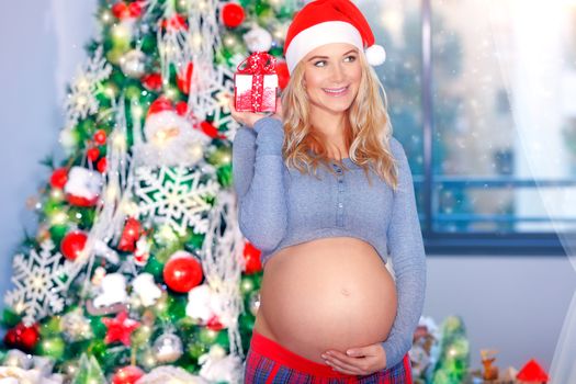 Happy pregnant woman in Christmas eve