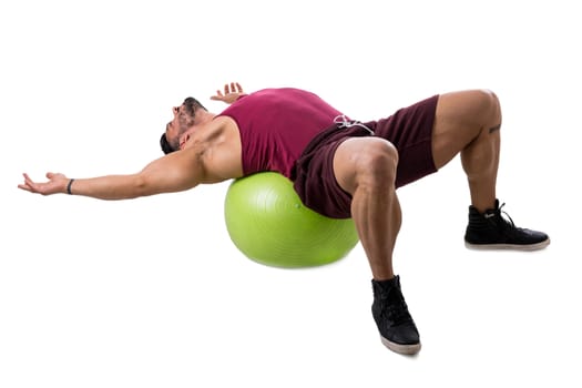 Muscleman exercising abs on an exercise ball