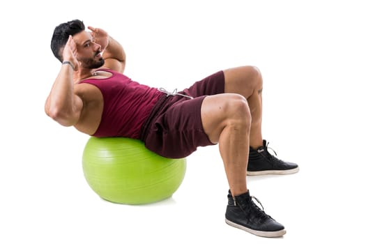 Muscleman exercising abs on an exercise ball