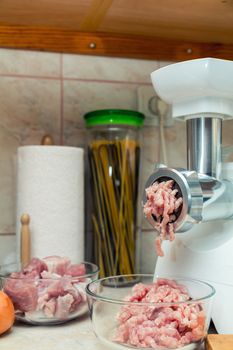 Meat-grinder is making pork stuffing