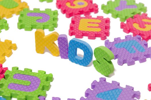 Foam puzzle letter uppercase with word Kids isolated on a white background.