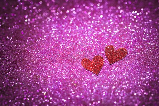 Blurred red felt heart on the sparkling ultaviolet background. Wedding and Valentine Day postcard concept