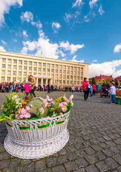 Uzhgorod, Ukraine - April 07, 2017: Celebrating Orthodox Easter in Uzhgorod on the Narodna square. Huge basket in front of  Transcarpathian Regional Administration building on a warm springtime day
