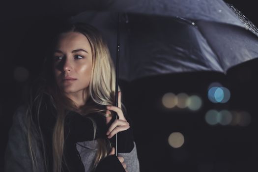 Beautiful sad woman at rainy night