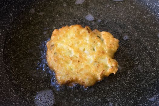 fritters while is frying in the pan