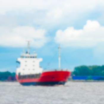 Red cargo ship - blurred image