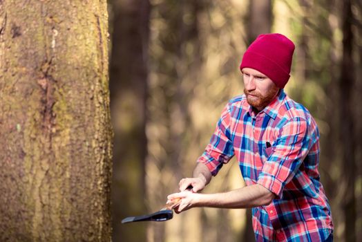 lumberjack while working with an ax, a forester - a hipster chop