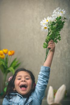 Excited baby girl with flowers
