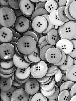 Plastic buttons background. Black and white photo.