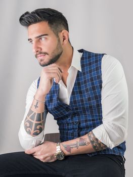 Trendy young man in studio shot wearing elegant vest
