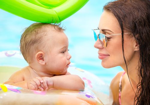 Beautiful mother with son in the pool