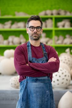 Portrait of Young Ceramist in the Modern Ceramic Workshop. Small Business Concept.