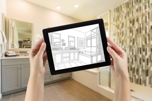 Hands Holding Computer Tablet with Master Bathroom Drawing on Screen and Photo Behind.
