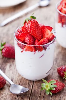 Glass of homemade yogurt with organic strawberries