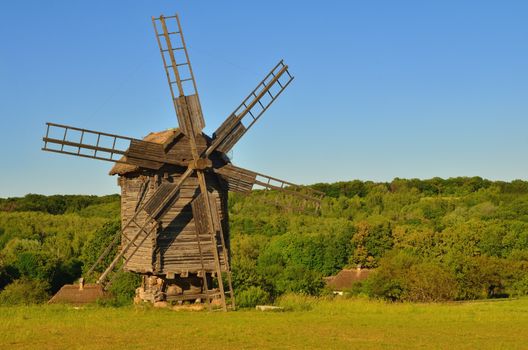 Large wooden windmill in the steppe on a lawn