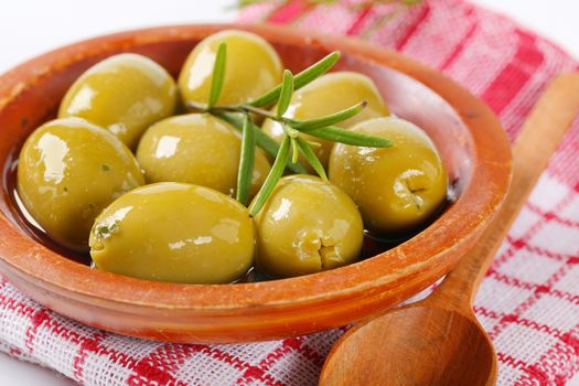 bowl of green olives with rosemary