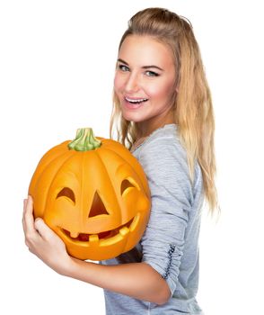 Portrait of beautiful blond female with holding in hands pumpkin with carved face isolated on white background, happy Halloween holiday