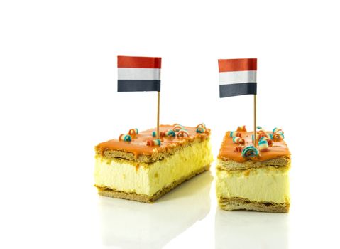 two orange tompouce, the traditional dutch pastry with the dutch flag , mostly on kingsday, therefore the color is orange, the dutch traditional color