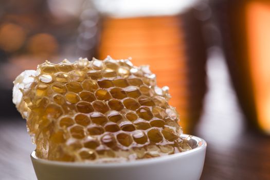 Jar of honey with honeycomb