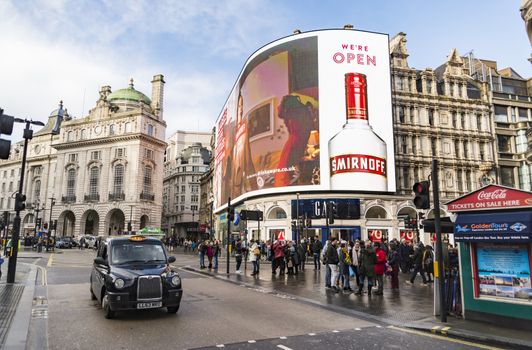 LONDON - DECEMBER 29: view of Piccadilly Circus with cabs , buses and crowds on December 29, 2017 in London UK. Famous advertisements have been here for at least 20 years and are considered symbols of famous square.