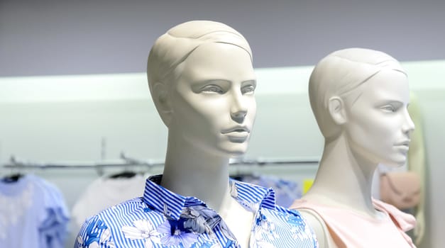 Closeup plastic mannequin heads against blurred shop background