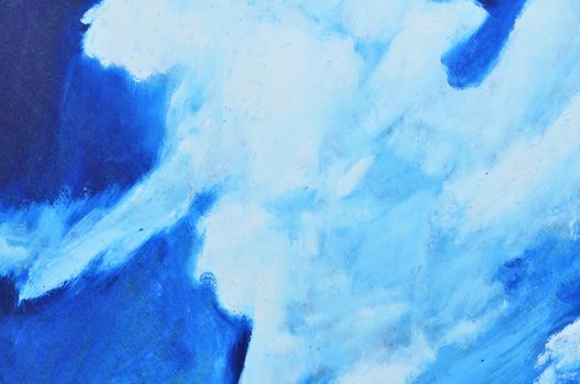 White watercolor paints on a blue canvas.