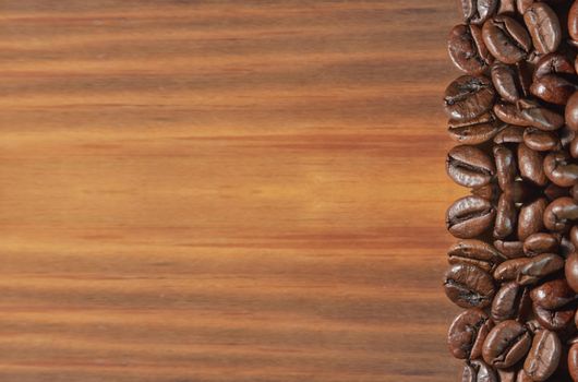 Coffee bean on a brown wooden background.