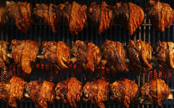 Pork knuckles slowly cooked at rotation grill