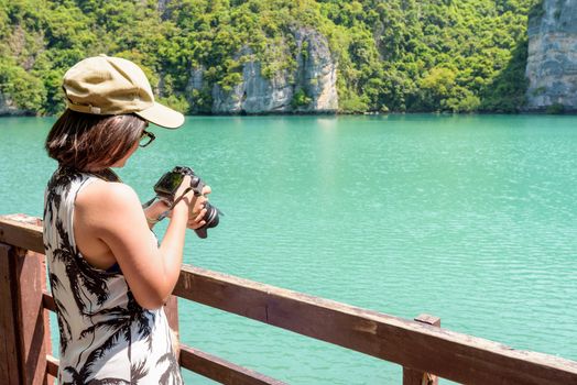 Woman tourist taking photos Thale Nai