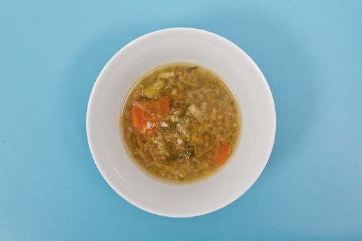 Miso vegetable soup with vegetables on a blue