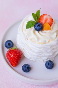 Meringue, Pavlova cake with strawberries, blueberries and mint