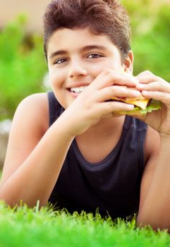 Happy boy eating burger