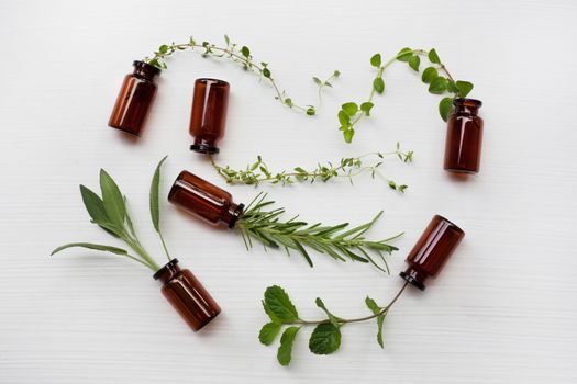 Top view, Bottle of essential oil with herbs