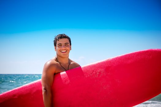 Joyful boy with surfboard