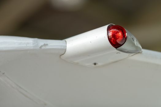 Wing of an airplane with red position light