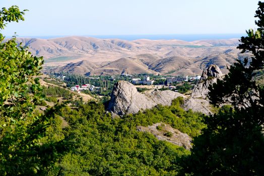 A small village surrounded by boundless mountains on the background of the Black Sea