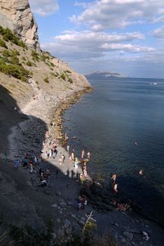 beautiful Crimean slopes on the shore of the Black sea.Tipping on the beach