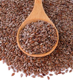Flax seeds heap in wood spoon 