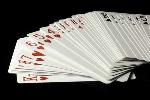 Playing Cards Spread Out on black background.