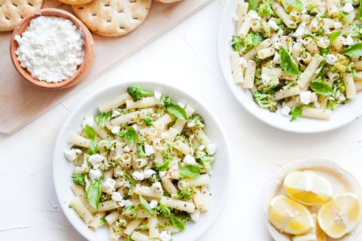 Plates Of Pasta With Broccoli And Feta Cheese